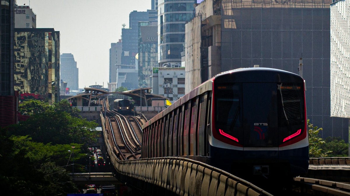 Bangkok Skytrain on an elevated track between city buildings